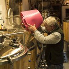 Mark adding one of the four varieties of malt needed for this brew